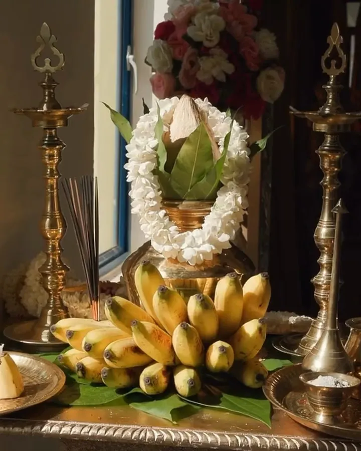 Bananas, a coconut and brass lamps set out for the rituals