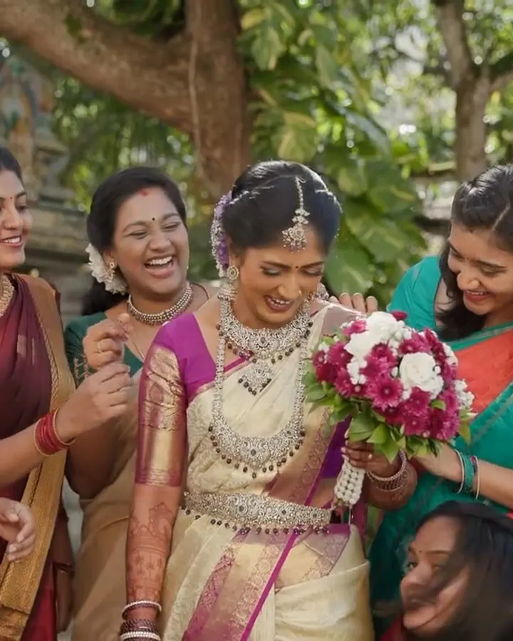 A bride in her silk wedding saree with her friends